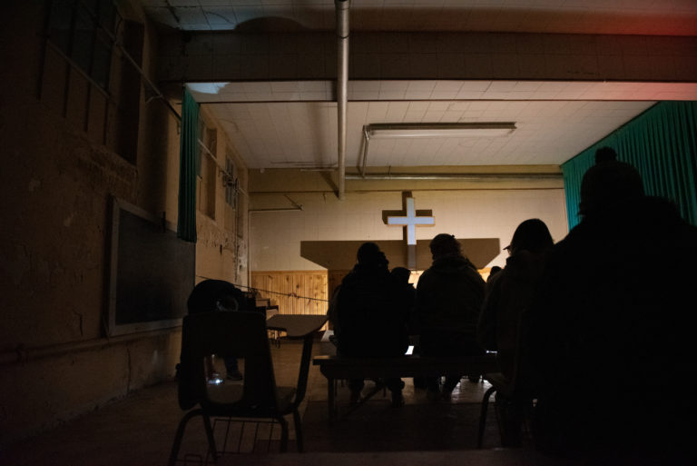 Guests sit in the old chapel as the tour leaders reach out to the paranormal and try to establish communication.